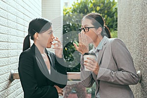 Women talking about office gossip
