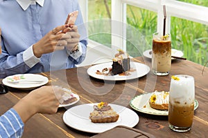 women talking and take a photo dessert and food in cafe restaurant, enjoy eating