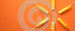 Women tampons on orange background, space for text