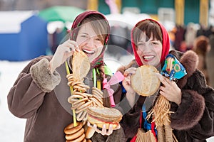 Women tasting pancake during Shrovetide