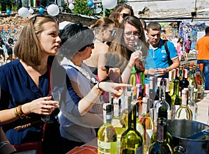 Women tasting white wine in outdoor bar
