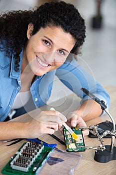 women technician fixing mobile phone repair and maintenance services