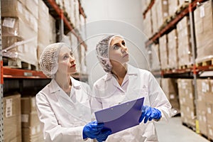 Women technologists at ice cream factory warehouse