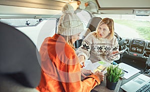 Women telecommuting in a camper van