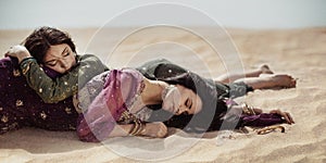 Women thirsty laying in a desert. Lost in desert durind sandshtorm