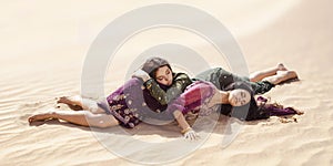 Women thirsty laying in a desert. Lost in desert durind sandshtorm