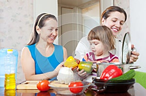 Women of three generations cook in the kitchen