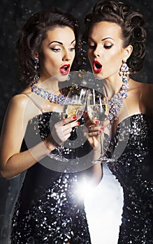 Women toasting at party with wineglasses photo