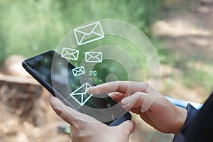 Women touching screen smartphone sending an email with letter icons, female checking message in mobile phone.