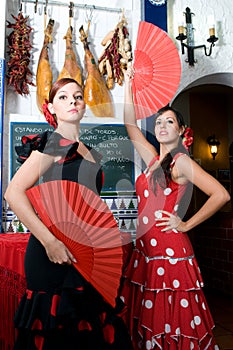 Women in traditional flamenco dresses dance during the Feria de Abril on April Spain photo