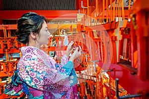 Women in traditional japanese kimonos at Fushimi Inari Shrine in Kyoto, Japan