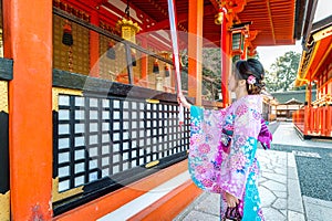 Women in traditional japanese kimonos at Fushimi Inari Shrine in Kyoto, Japan photo