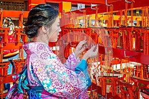 Women in traditional japanese kimonos at Fushimi Inari Shrine in Kyoto, Japan