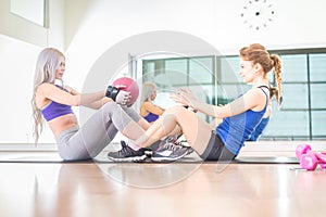 Women training abs in a gym