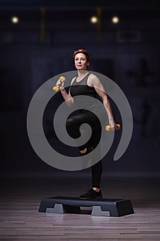 Women training on stepper isolated in fitness club