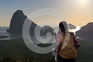 Women traveler with backpack checks map to find directions