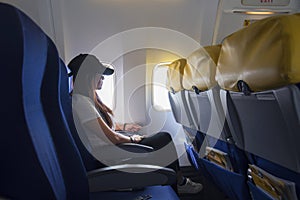 Women traveling by an airplane. Women sitting by aircraft window and looking outside.