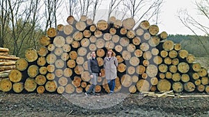 Women before tree timbers in rural countryside