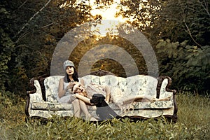 Women in twenties fashion on vintage couch photo