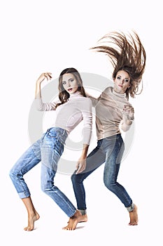 Women are two models in fashionable clothes in jeans in the Stud