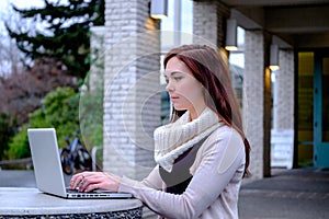 Women at university typing on a computer