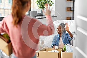 women unpacking boxes and moving to new home