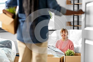 women unpacking boxes and moving to new home