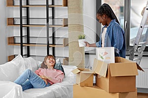 women unpacking boxes and moving to new home