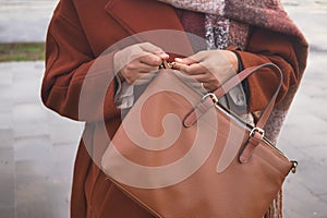 women Unzipping her purse close up