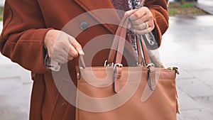 women Unzipping her purse close up