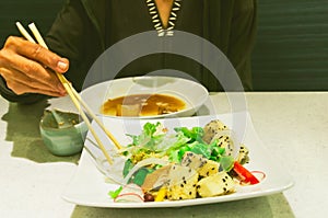 Women use chopsticks with tofu salads