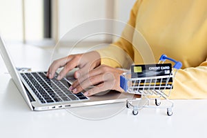 Women use laptop register via credit cards to make online purchases,