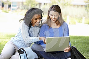 Women using laptop outdoors