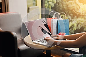 Women using laptop for shopping online and earn points to website.