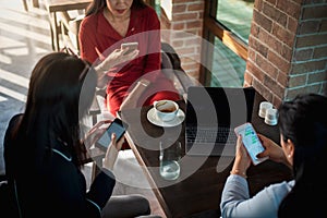 Women using phones in a bar