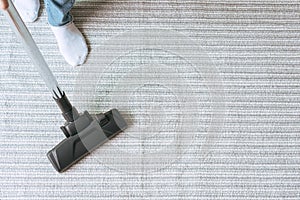 Women using vacuum cleaner cleaning carpet in the living room. copy space, top view