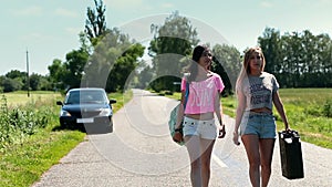 Women walking on road with rusty canister in hand