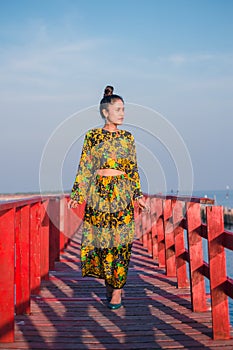 Women are walking on a wooden bridge