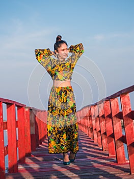 Women are walking on a wooden bridge