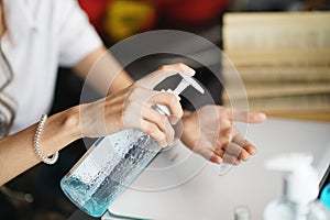 Women washing hands with alcohol gel or antibacterial soap sanitizer after using a public restroom.Hygiene concept. prevent the