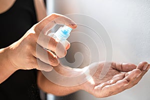 Women washing hands with alcohol spray clean hands hygiene prevention and disinfection of coronavirus and other viruses