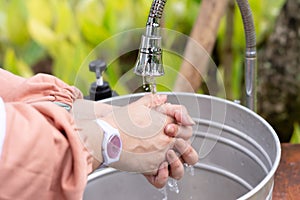 women washing their hands, maintaining hygiene and health