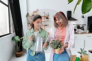 Women with a watering can and a houseplant