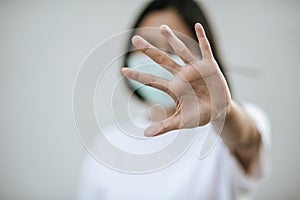 Women wear masks and forbid by raising their hands in front