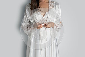 Women wearing white nightgown & long sleeve satin robe with floral lace