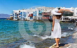 Women in white dress in front of Little Venice, Mykonos