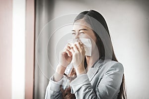 Women who have a cough and are ill with a flu infection - therefore have to use toilet paper to cover the mouth photo