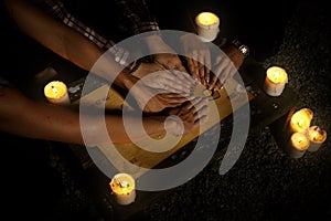 Women witches with spiritual board ouija summoning ghosts