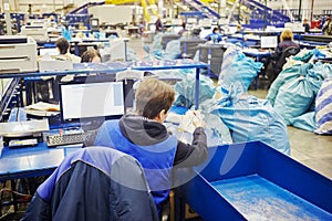 Women work at conveyor with parcels in the