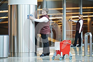 Women workers cleaning indoor interior